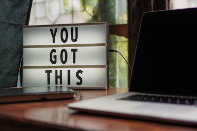 Laptop with "You got this" sign.